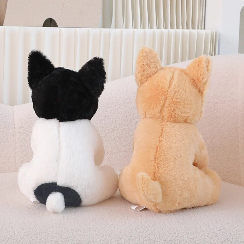 Deux peluches chiens Bouledogue Français de dos sur canape