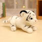 Peluche bébé tigre blanc couché sur une table