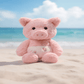 Peluche cochon corse assis à la plage