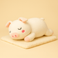 Peluche cochon endormi sur une couverture