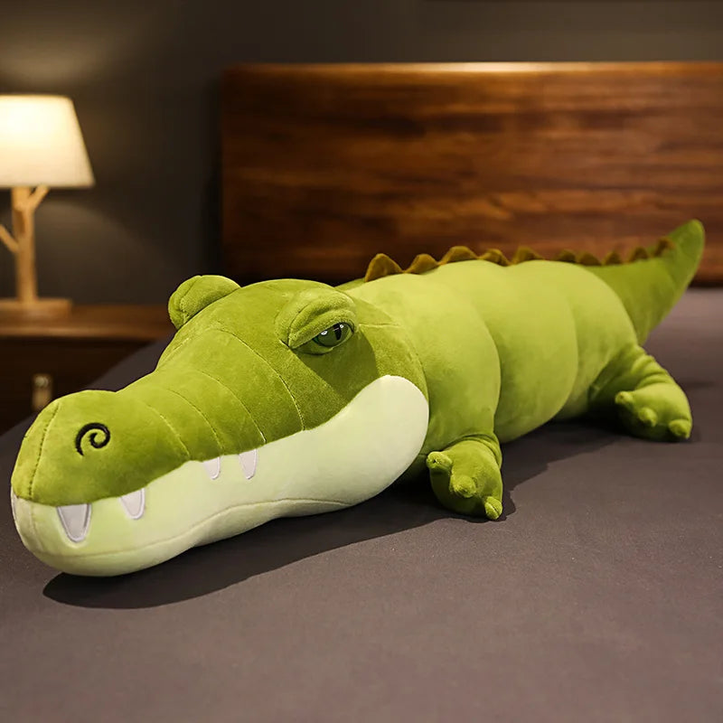 Peluche crocodile vert clair xxl sur un lit