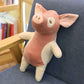Peluche des petits cochons blanche sur un fauteuil