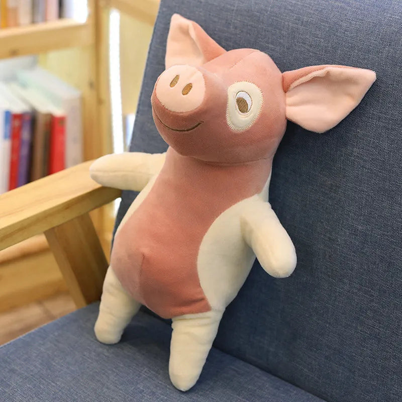 Peluche des petits cochons blanche sur un fauteuil