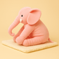 Peluche éléphant rose sur une couverture 