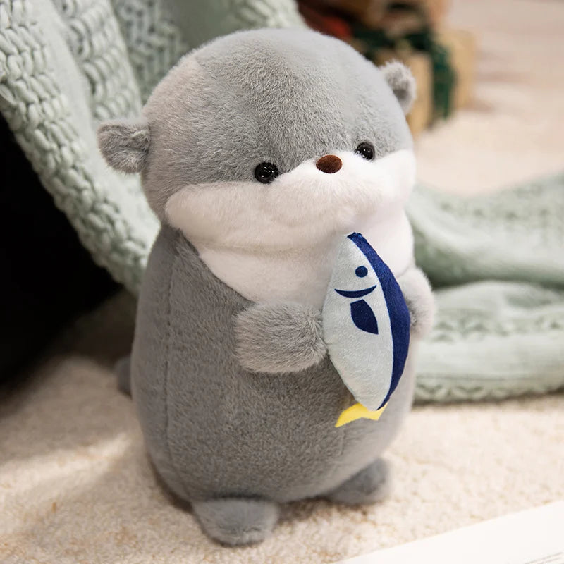 Peluche loutre avec son poisson