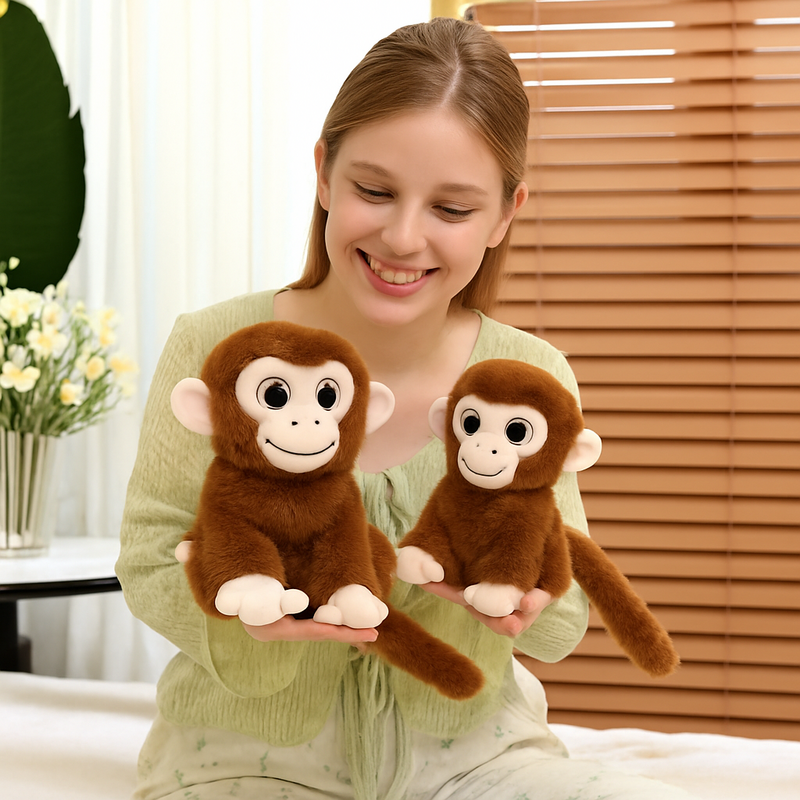 Deux peluches singes aux gros yeux tenus par une fille dans les mains