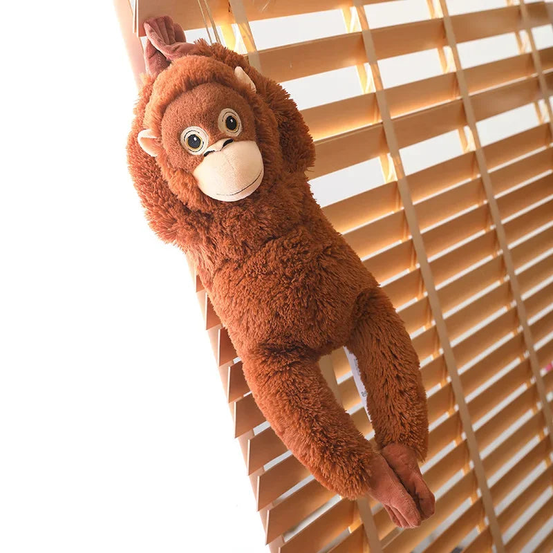 Peluche singe orang-outan accroché sur un store en bois
