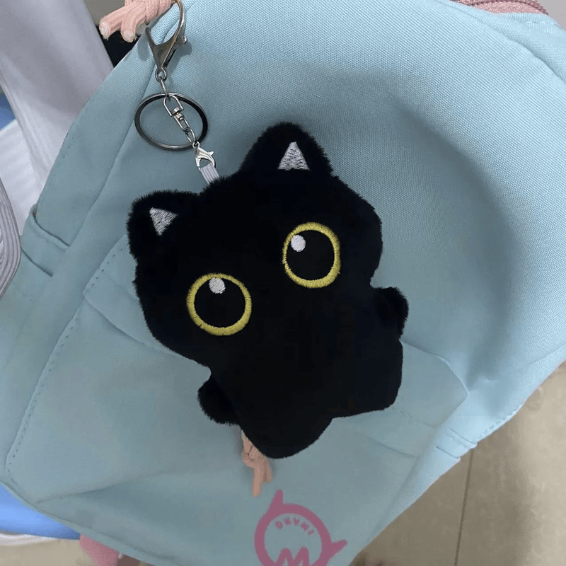 Petit chat noir en peluche